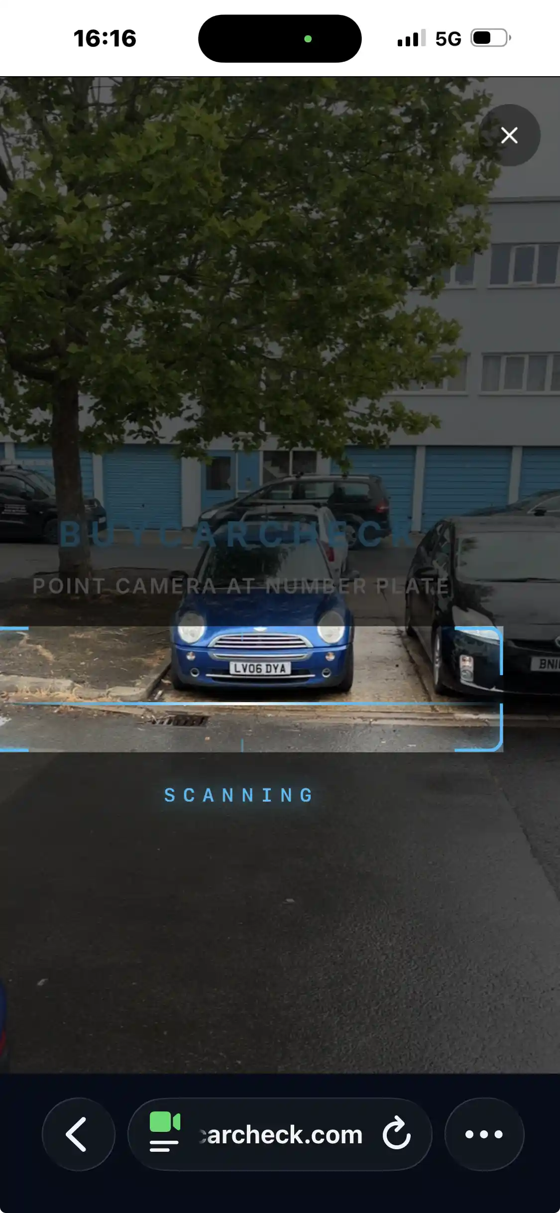 Phone camera pointed at a UK number plate on a car